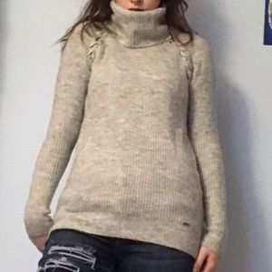 grey turtleneck with crisscross detailing shoulder